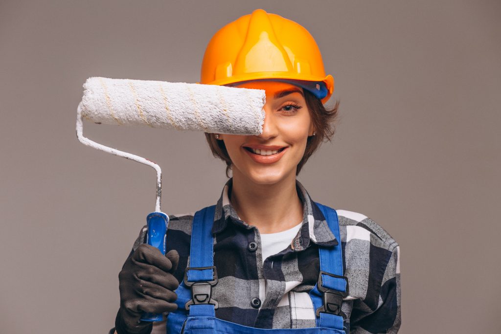 Portrait of repairer woman with painting roller isolated